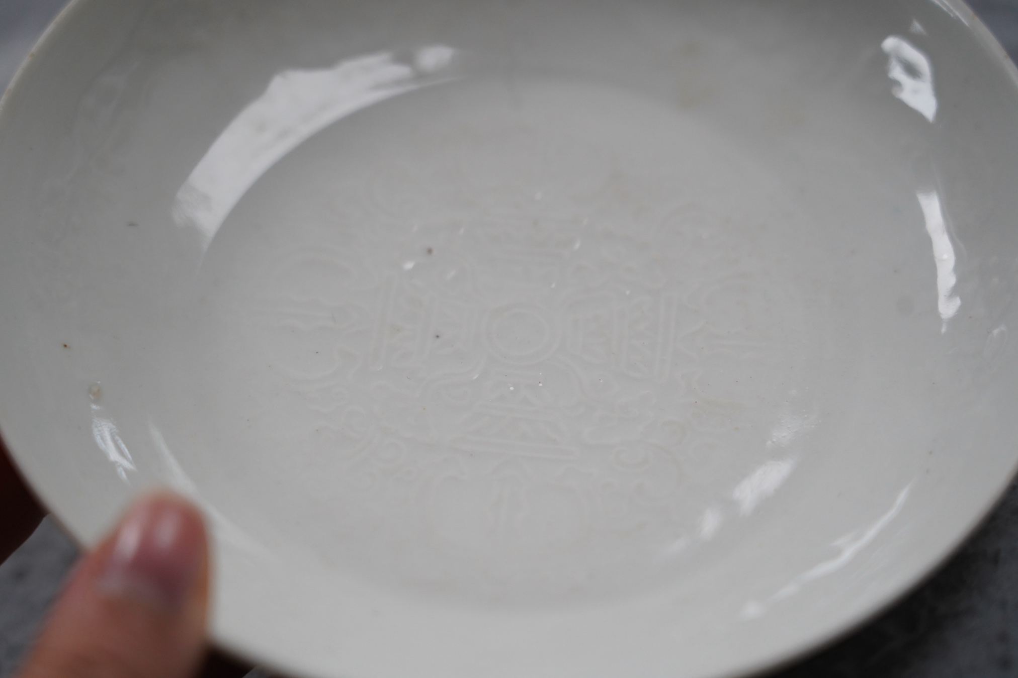 A Chinese moulded white glazed saucer dish, Yongle mark, Republic period